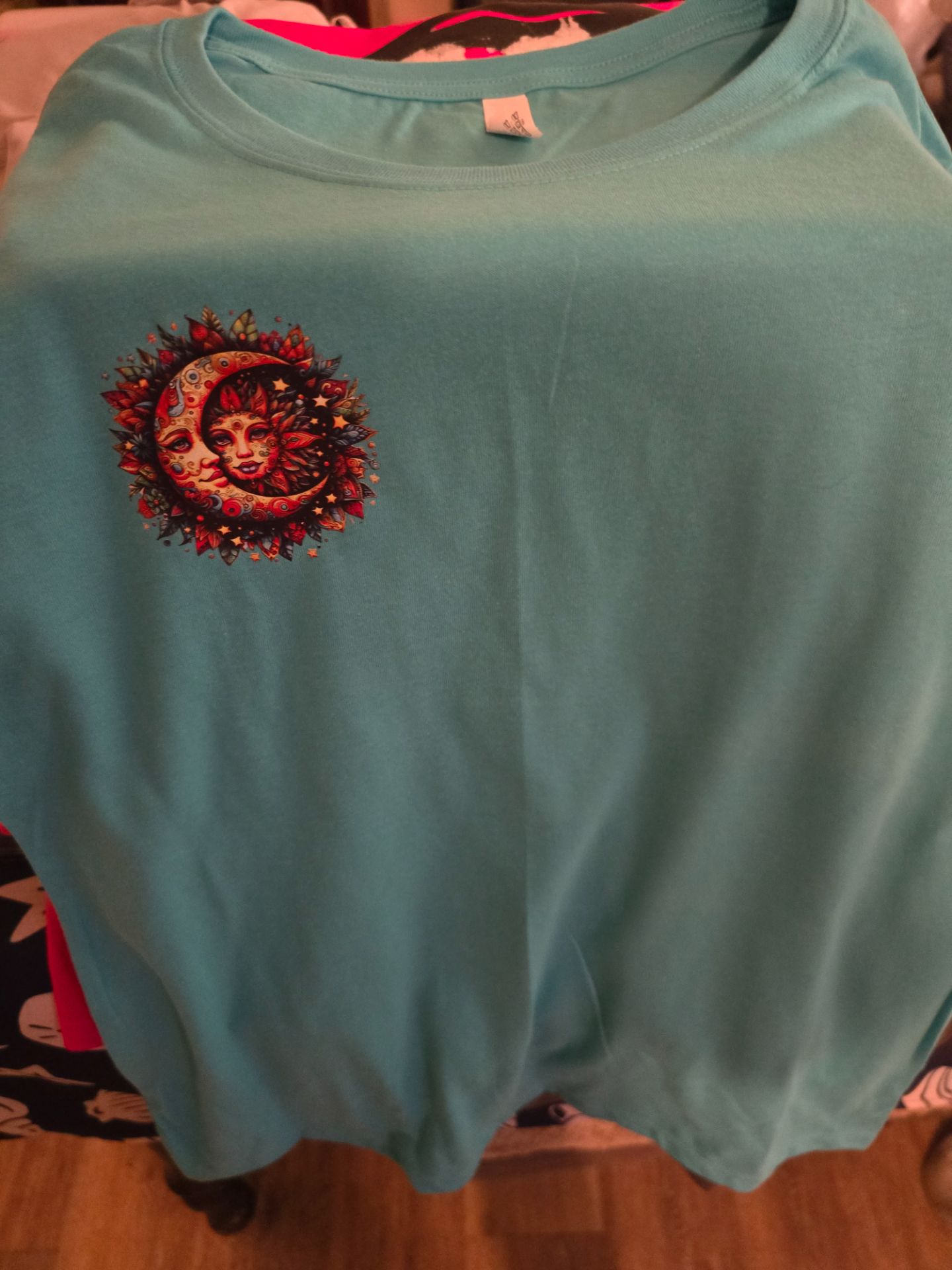 Aqua shirt with celestial sun and moon pocket design